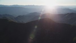 5K aerial stock footage tilt from shadowy slopes to hazy mountains, San Luis Obispo County, California Aerial Stock Footage | DFKSF17_019