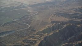 5K aerial stock footage of flying by a dry riverbed and Caliente Range mountains, Cuyama Valley, California Aerial Stock Footage | DFKSF17_025