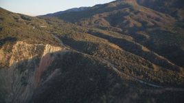 5K aerial stock footage tilt up mountainside to a road, Los Padres National Forest, California, sunset Aerial Stock Footage | DFKSF17_044