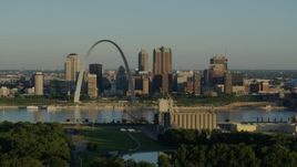 5.7K aerial stock footage of a grain elevator and park looking toward the Arch and skyline by Mississippi River, sunrise, Downtown St. Louis, Missouri Aerial Stock Footage | DX0001_000518