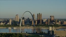 5.7K aerial stock footage flying over park near grain elevator approaching the Arch and skyline, sunrise, Downtown St. Louis, Missouri Aerial Stock Footage | DX0001_000519
