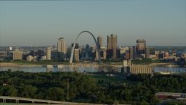 5.7K aerial stock footage of the Arch and skyline while flying away from a park and over interstate, Downtown St. Louis, Missouri Aerial Stock Footage | DX0001_000521