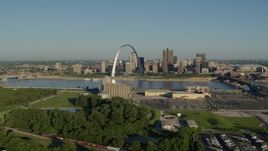 5.7K aerial stock footage of a park and factory along the river with views of the Arch and skyline, sunrise, Downtown St. Louis, Missouri Aerial Stock Footage | DX0001_000536