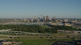 5.7K aerial stock footage of  a park and freeway with views of skyline and Arch, sunrise, Downtown St. Louis, Missouri Aerial Stock Footage | DX0001_000544