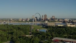 5.7K aerial stock footage of ascending over freeway toward park in East St. Louis with views of skyline and Arch, sunrise, Downtown St. Louis, Missouri Aerial Stock Footage | DX0001_000546