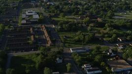 5.7K aerial stock footage approaching apartment buildings among trees, sunrise, East St Louis, Illinois Aerial Stock Footage | DX0001_000561