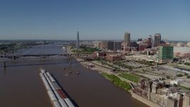 5.7K aerial stock footage flying over Mississippi River with barges near Downtown St. Louis, Missouri Aerial Stock Footage | DX0001_000577