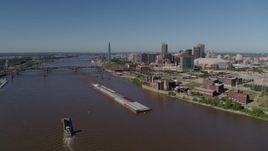 5.7K aerial stock footage of barges in the Mississippi River and the city in the distance, Downtown St. Louis, Missouri Aerial Stock Footage | DX0001_000581