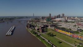 5.7K aerial stock footage of barges in the Mississippi River near riverfront buildings, Downtown St. Louis, Missouri Aerial Stock Footage | DX0001_000582