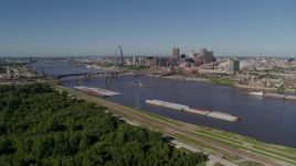 5.7K aerial stock footage flyby barges on the river and over trees, Downtown St. Louis, Missouri Aerial Stock Footage | DX0001_000585
