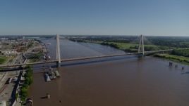 5.7K aerial stock footage reverse from cable-stayed bridge spanning the Mississippi River revealing barges, St. Louis, Missouri Aerial Stock Footage | DX0001_000589