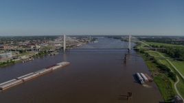 5.7K aerial stock footage of a reverse of barges on the river and a cable-stayed bridge, St. Louis, Missouri Aerial Stock Footage | DX0001_000590