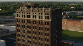 5.7K aerial stock footage of approaching the abandoned office building at sunset in East St. Louis, Illinois Aerial Stock Footage | DX0001_000673