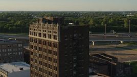 5.7K aerial stock footage of flying around an abandoned brick building at sunset in East St. Louis, Illinois Aerial Stock Footage | DX0001_000677