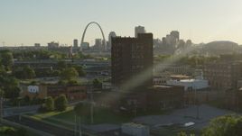 5.7K aerial stock footage approach a brick building at sunset in East St. Louis, Illinois with the Gateway Arch in background Aerial Stock Footage | DX0001_000678