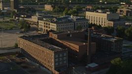 5.7K aerial stock footage orbit abandoned hospital across from a federal courthouse at sunset in East St. Louis, Illinois Aerial Stock Footage | DX0001_000683