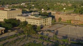 5.7K aerial stock footage of flying from a federal courthouse at sunset in East St. Louis, Illinois Aerial Stock Footage | DX0001_000693