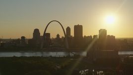 5.7K aerial stock footage of the setting sun behind the Downtown St. Louis, Missouri skyline Aerial Stock Footage | DX0001_000697