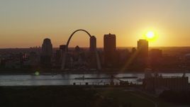 5.7K aerial stock footage of the Gateway Arch and Downtown St. Louis, Missouri skyline with the setting sun in the background Aerial Stock Footage | DX0001_000715