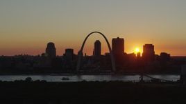 5.7K aerial stock footage of the Gateway Arch and the Downtown St. Louis, Missouri skyline in silhouette at sunset Aerial Stock Footage | DX0001_000725