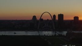 5.7K aerial stock footage of the Gateway Arch and Downtown St. Louis, Missouri skyline in silhouette at sunset Aerial Stock Footage | DX0001_000726