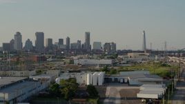 5.7K aerial stock footage ascend with view of city's skyline and Gateway Arch seen from warehouses, Downtown St. Louis, Missouri Aerial Stock Footage | DX0001_000835