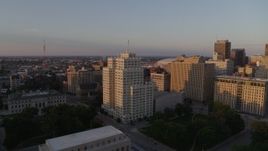 5.7K aerial stock footage fly away from a tall apartment building, reveal museum at sunset, Downtown St. Louis, Missouri Aerial Stock Footage | DX0001_000857