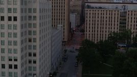 5.7K aerial stock footage flyby office building to reveal city street at twilight, Downtown St. Louis, Missouri Aerial Stock Footage | DX0001_000884