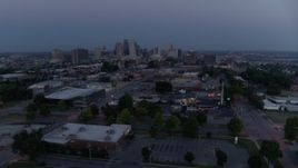 5.7K aerial stock footage reverse view of the city skyline at twilight, seen from industrial area in Downtown Kansas City, Missouri Aerial Stock Footage | DX0001_000977