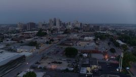 5.7K aerial stock footage fly away from industrial area with view of skyline at twilight, Downtown Kansas City, Missouri Aerial Stock Footage | DX0001_000979