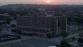 5.7K aerial stock footage of approaching a brick office building at sunrise in Kansas City, Missouri Aerial Stock Footage | DX0001_000989