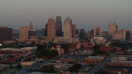 5.7K aerial stock footage of a reverse view of the city skyline at sunrise, Downtown Kansas City, Missouri Aerial Stock Footage | DX0001_000998