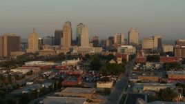 5.7K aerial stock footage flyby the city skyline at sunrise, seen from an industrial area, Downtown Kansas City, Missouri Aerial Stock Footage | DX0001_001005