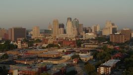 5.7K aerial stock footage passing by the city skyline at sunrise, seen from an industrial area, Downtown Kansas City, Missouri Aerial Stock Footage | DX0001_001007