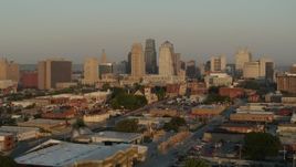 5.7K aerial stock footage flyby and away from the city skyline at sunrise, seen from an industrial area, Downtown Kansas City, Missouri Aerial Stock Footage | DX0001_001008