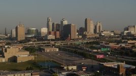 5.7K aerial stock footage flyby the downtown skyline at sunrise, reveal freeway interchange, Downtown Kansas City, Missouri Aerial Stock Footage | DX0001_001016