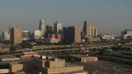 5.7K aerial stock footage reverse view of the downtown skyline and Hwy 71 at sunrise, Downtown Kansas City, Missouri Aerial Stock Footage | DX0001_001021