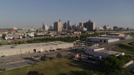5.7K aerial stock footage of descend toward warehouse buildings, freeway near skyline of Downtown Kansas City, Missouri Aerial Stock Footage | DX0001_001046