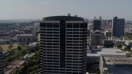 5.7K aerial stock footage of circling the top of a Crown Center office building in Kansas City, Missouri, skyline in background Aerial Stock Footage | DX0001_001097