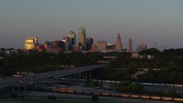 5.7K aerial stock footage of the setting sun reflecting off skyscrapers in Downtown Kansas City, Missouri Aerial Stock Footage | DX0001_001171