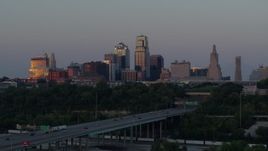 5.7K aerial stock footage of city skyline reflecting the setting sun in Downtown Kansas City, Missouri, seen from I-670, twilight Aerial Stock Footage | DX0001_001179