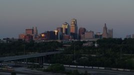 5.7K aerial stock footage reverse view of city skyline reflecting the setting sun in Downtown Kansas City, Missouri, twilight Aerial Stock Footage | DX0001_001180