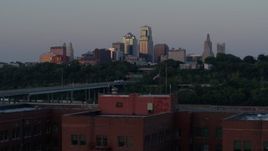 5.7K aerial stock footage fly away from skyline at twilight to reveal brick building, Downtown Kansas City, Missouri Aerial Stock Footage | DX0001_001182