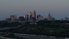 5.7K aerial stock footage passing the city's skyline lit by the setting sun in Downtown Kansas City, Missouri, twilight Aerial Stock Footage | DX0001_001191