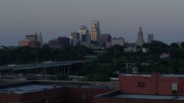 5.7K aerial stock footage of city skyline while descending by brick building at twilight, Downtown Kansas City, Missouri Aerial Stock Footage | DX0001_001197