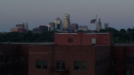 5.7K aerial stock footage ascend by brick building at twilight, reveal skyline of Downtown Kansas City, Missouri Aerial Stock Footage | DX0001_001198