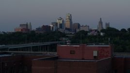 5.7K aerial stock footage of the skyline at twilight, descend to reveal brick building, Downtown Kansas City, Missouri Aerial Stock Footage | DX0001_001199