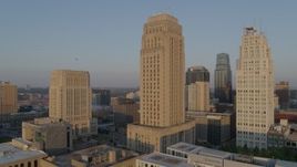 5.7K aerial stock footage of a reverse view of city hall and skyscraper at sunrise, Downtown Kansas City, Missouri Aerial Stock Footage | DX0001_001212