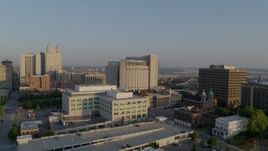 5.7K aerial stock footage reverse view of government offices, federal courthouse at sunrise, Downtown Kansas City, Missouri Aerial Stock Footage | DX0001_001227