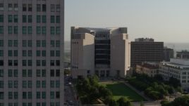 5.7K aerial stock footage flyby the federal courthouse for closer view of skyscraper at sunrise, Downtown Kansas City, Missouri Aerial Stock Footage | DX0001_001258